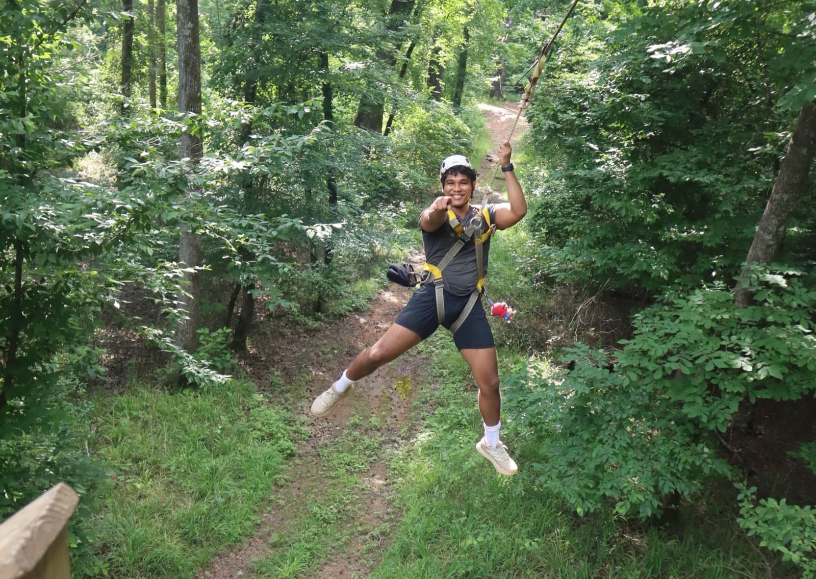 Fontanel guest pointing while riding the Express Zip through the forest in Whites Creek, Tennessee